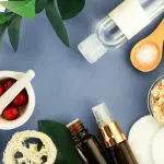 spa items arranged on a blue background. 2024 best holistic skincare treatments
