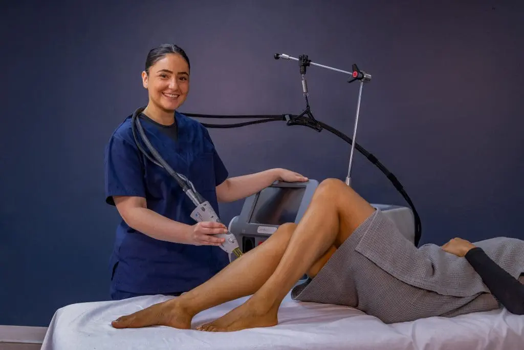 student performing a treatment on a client's leg