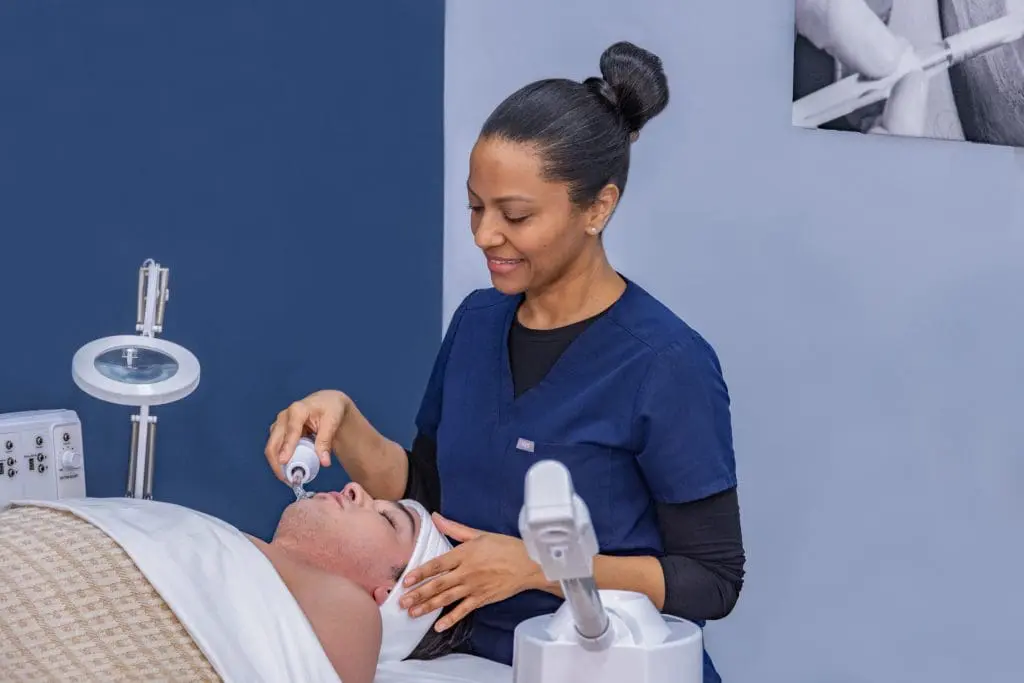 esthetician performing an advanced facial treatment