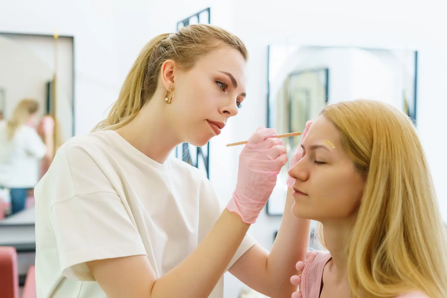Student practicing makeup application techniques as part of Atelier Esthetique’s esthetician licensing program in New York City.